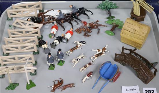 A collection of mostly Britains hunting hounds, huntsmen and ladies on horseback, windmill, haystack and bridge, etc